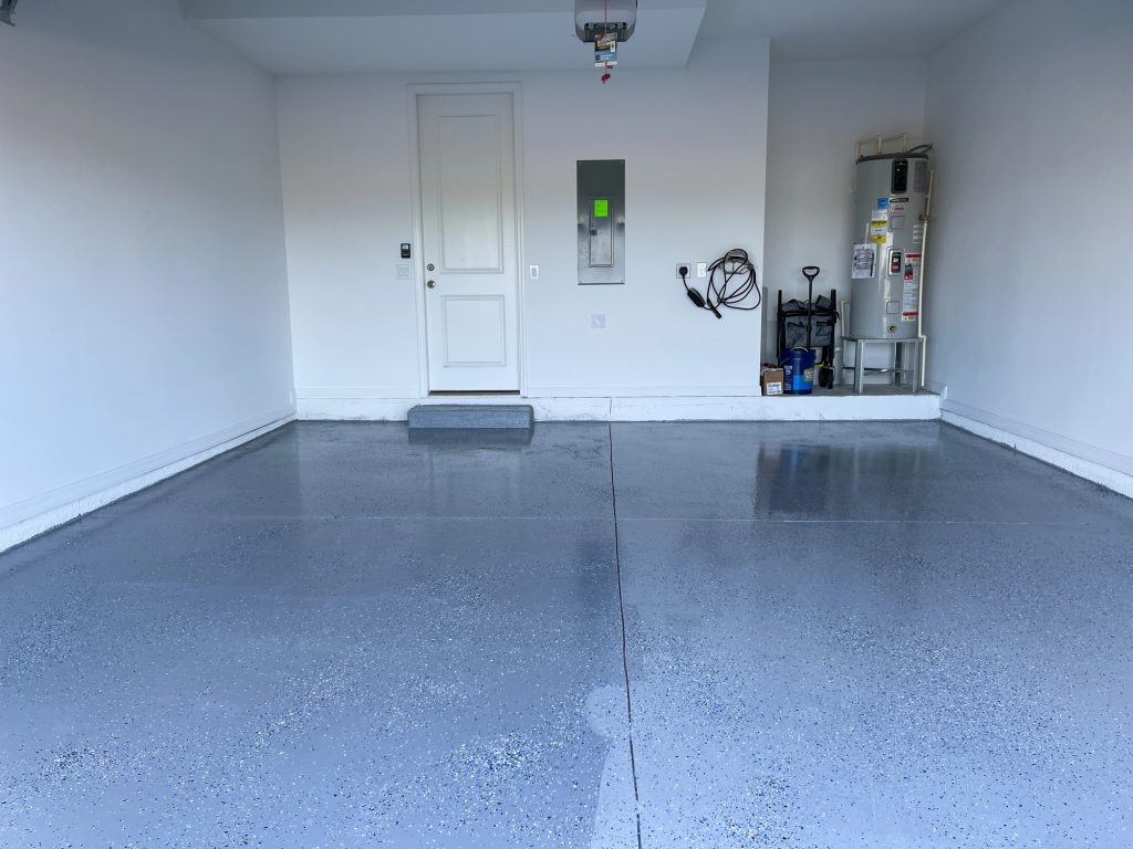 A freshly painted with a gray epoxy finish sprinkled with blue, black and white plastic chips.